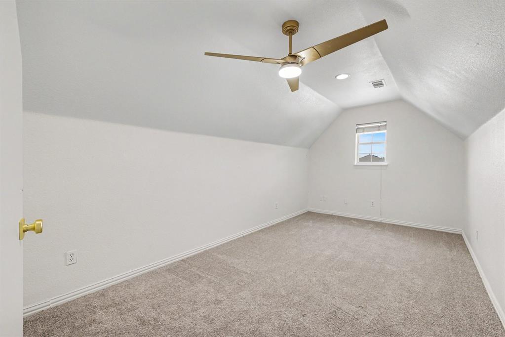 307 Dixon Street Terrell, TX 75160 - Photo 25 of 32 Attic room featuring a sloped ceiling, light-toned carpet, a gold-toned ceiling fan with integrated lighting, recessed lighting, and a single window