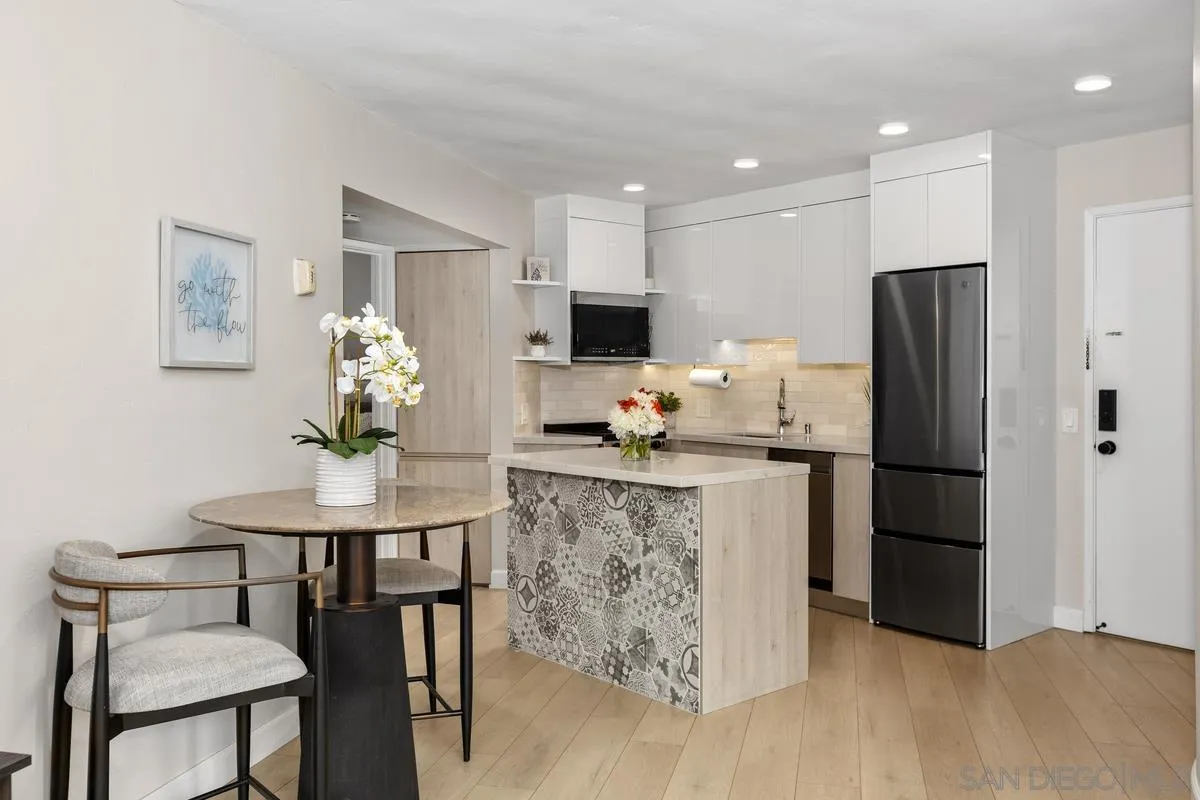 8040 Girard Avenue, Unit 2 La Jolla, CA 92037 - Photo 11 of 27 a kitchen with stainless steel appliances granite countertop a refrigerator and a stove top oven
