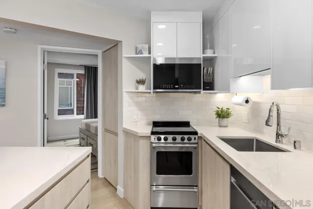 a kitchen with a sink and a stove top oven