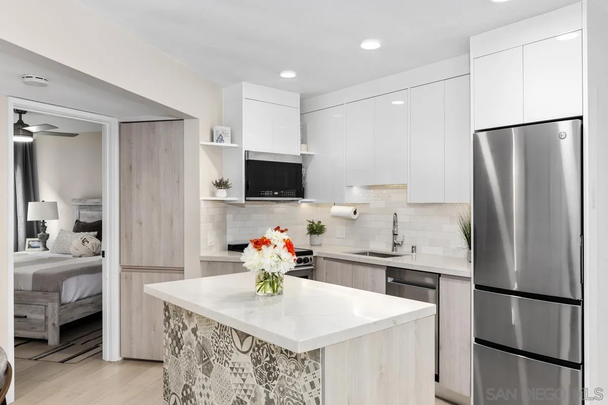 8040 Girard Avenue, Unit 2 La Jolla, CA 92037 - Photo 16 of 27 a kitchen with stainless steel appliances granite countertop a refrigerator and a sink