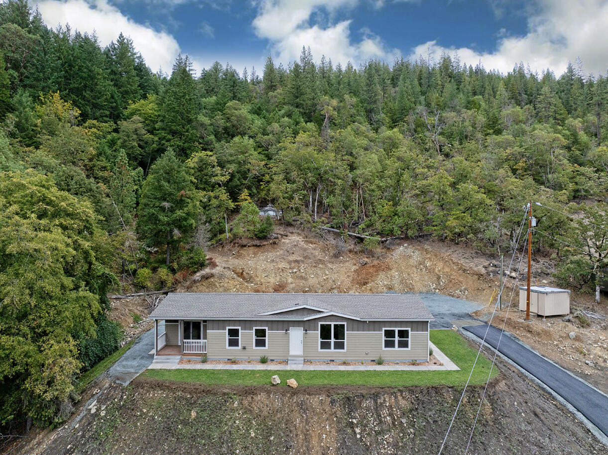 5572 Jumpoff Joe Creek Road Grants Pass, OR 97526 - Photo 33 of 38 a aerial view of a house next to a yard