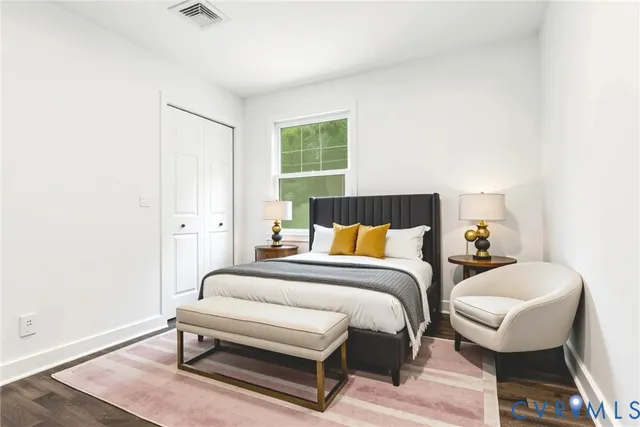 a bedroom with a bed and a night stand