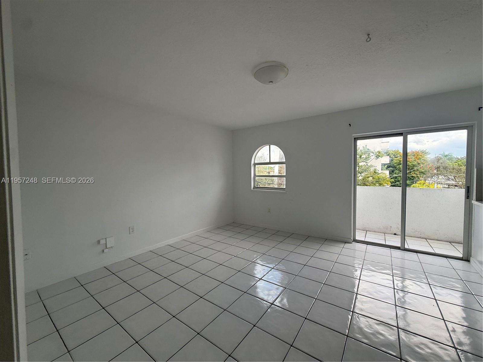 3052 Southwest 27th Avenue, Unit 301 Miami, FL 33133 - Photo 11 of 16 a view of an empty room and window