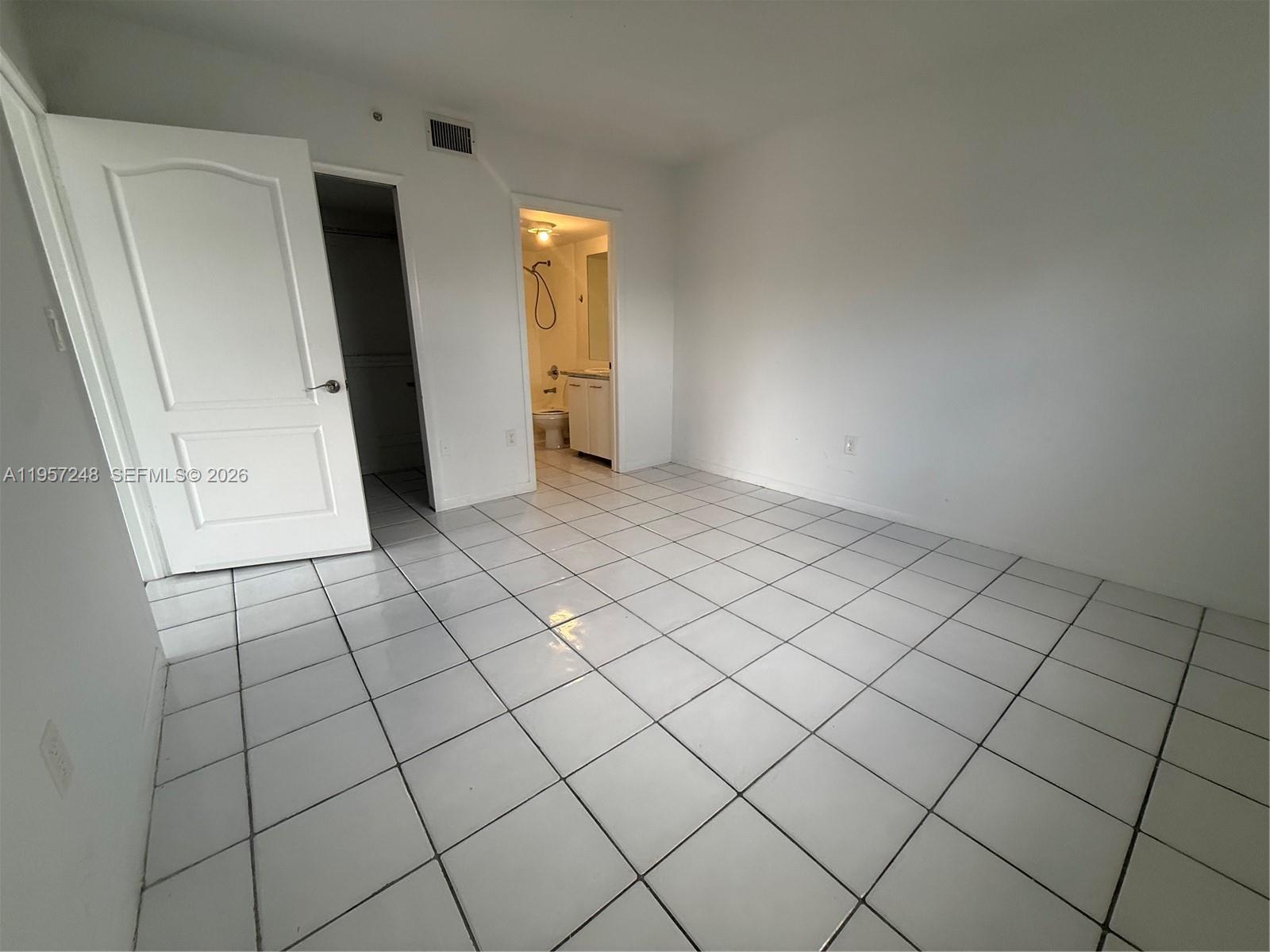 3052 Southwest 27th Avenue, Unit 301 Miami, FL 33133 - Photo 12 of 16 an empty room with windows