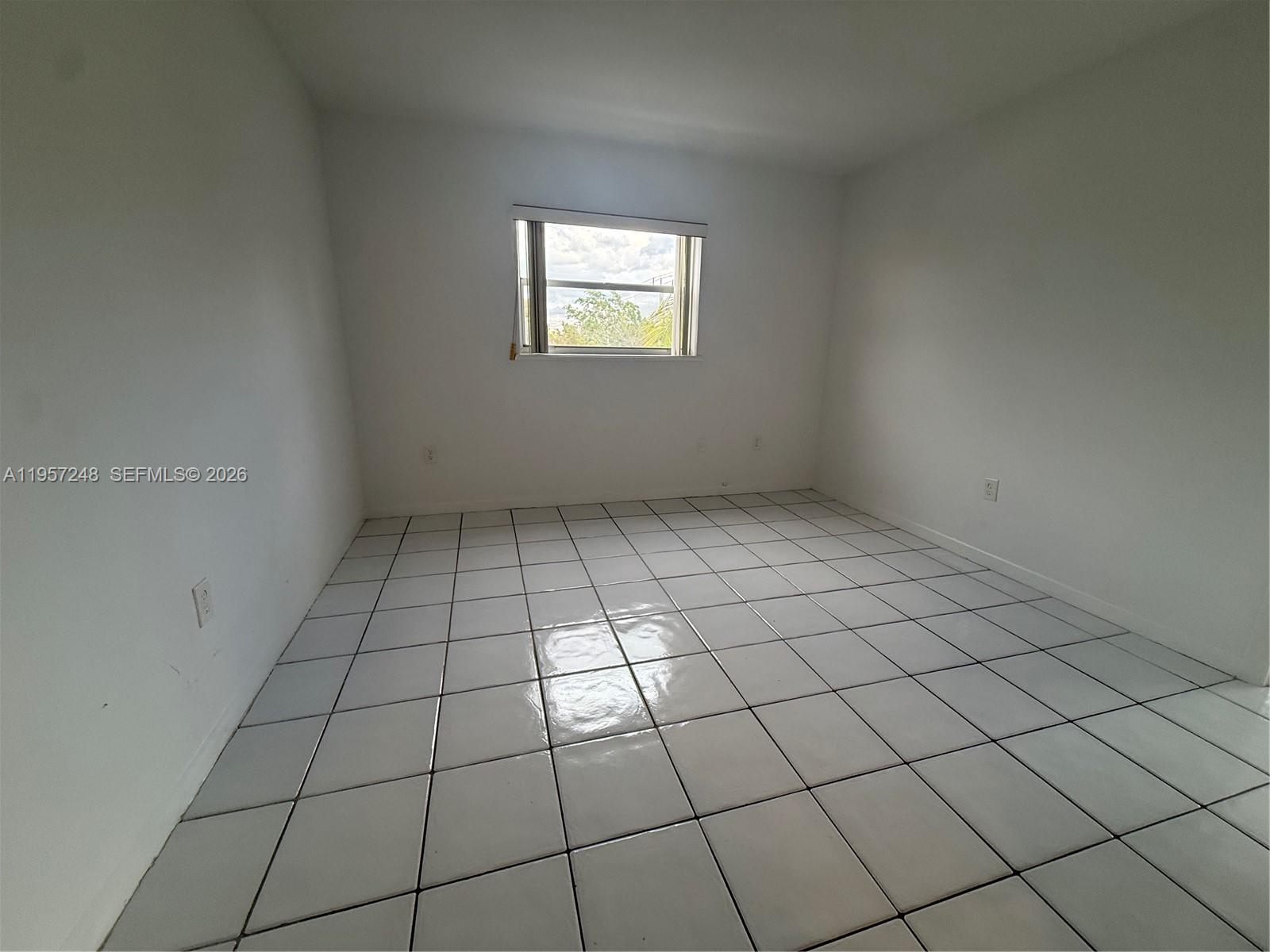 3052 Southwest 27th Avenue, Unit 301 Miami, FL 33133 - Photo 13 of 16 a view of an empty room and window