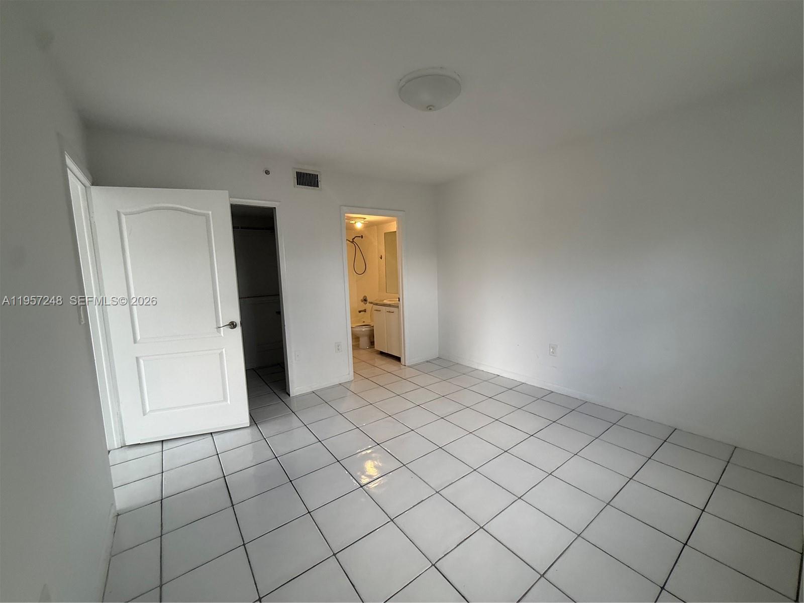 3052 Southwest 27th Avenue, Unit 301 Miami, FL 33133 - Photo 8 of 16 a view of an empty room and window