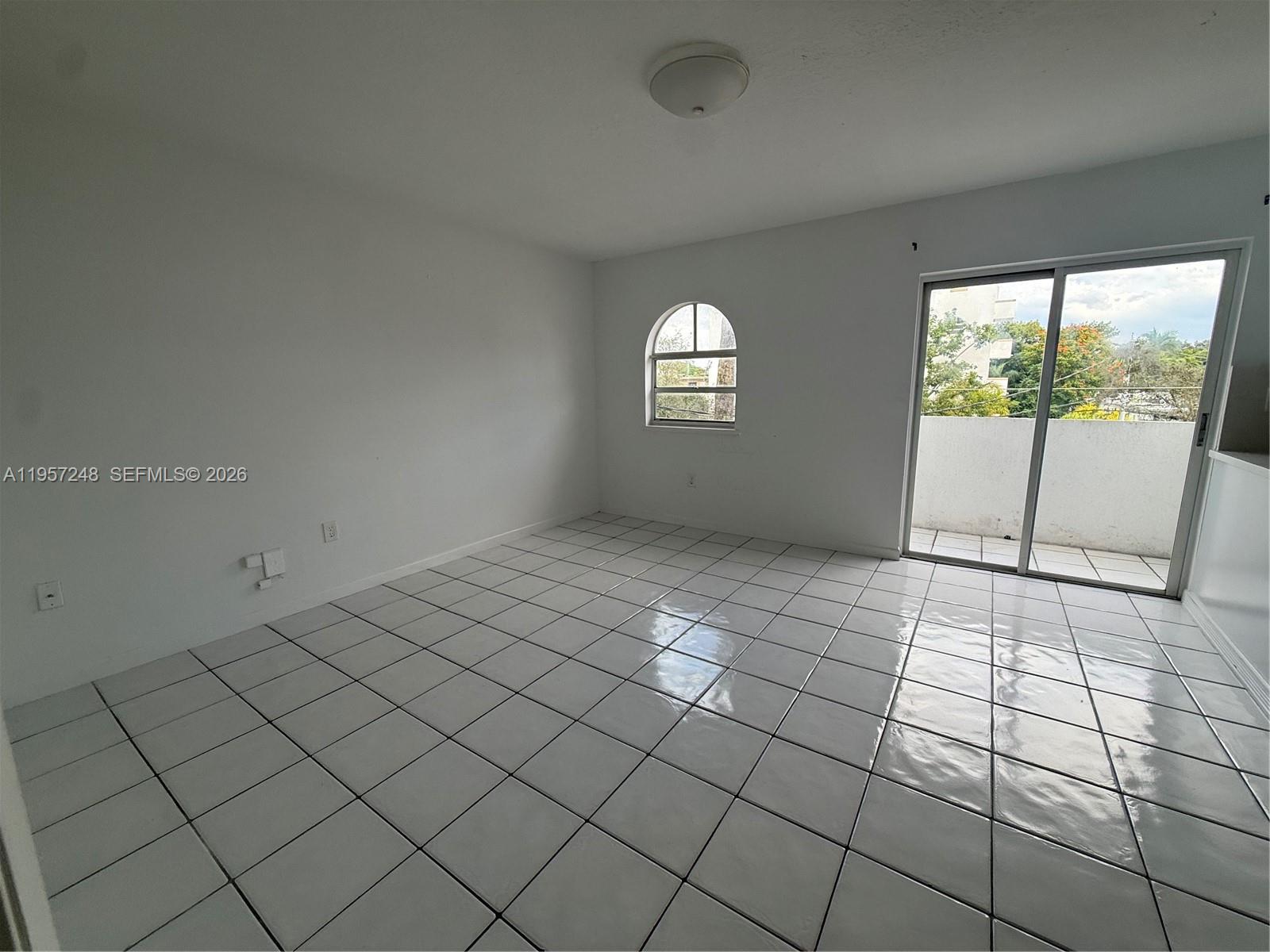 3052 Southwest 27th Avenue, Unit 301 Miami, FL 33133 - Photo 10 of 16 an empty room with windows