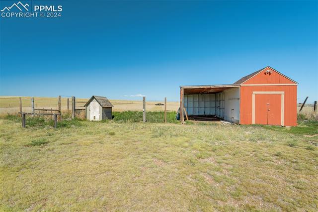 6240 Night Train Lane Yoder, CO 80864 - Photo 44 of 50 View of yard featuring a rural view and a storage shed