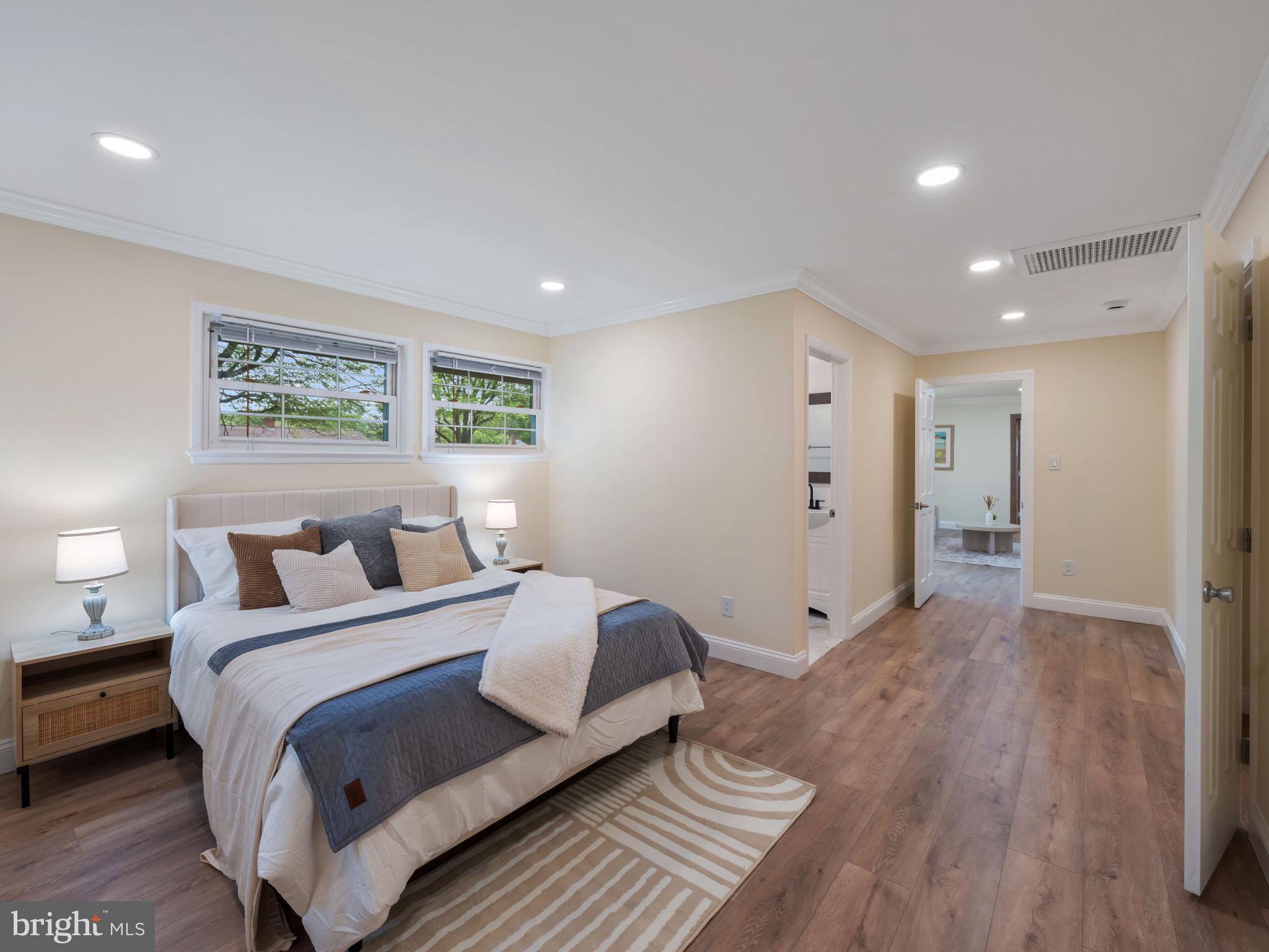5503 Blacksburg Road Springfield, VA 22151 - Photo 12 of 30 a spacious bedroom with a bed and a painting