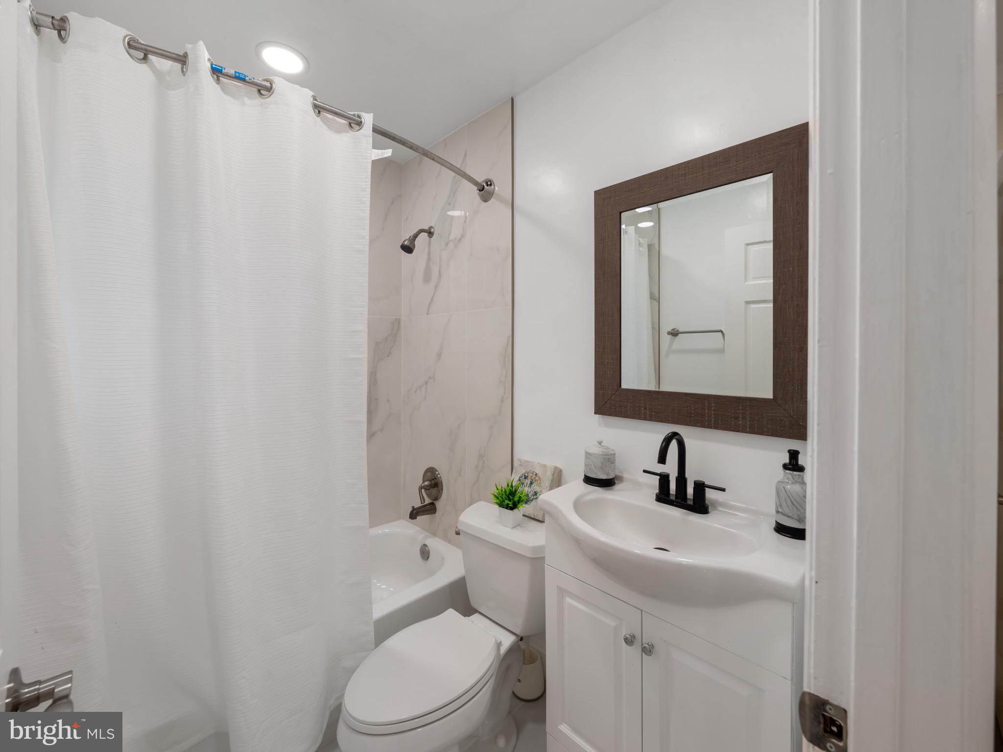 5503 Blacksburg Road Springfield, VA 22151 - Photo 13 of 30 a bathroom with a toilet sink vanity and mirror