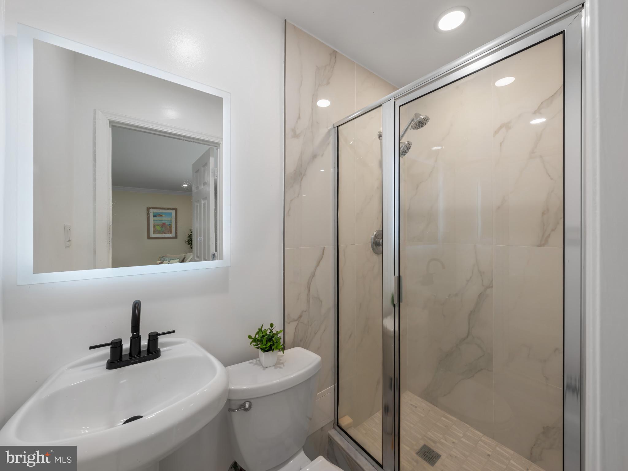 5503 Blacksburg Road Springfield, VA 22151 - Photo 15 of 30 a bathroom with a sink toilet and shower