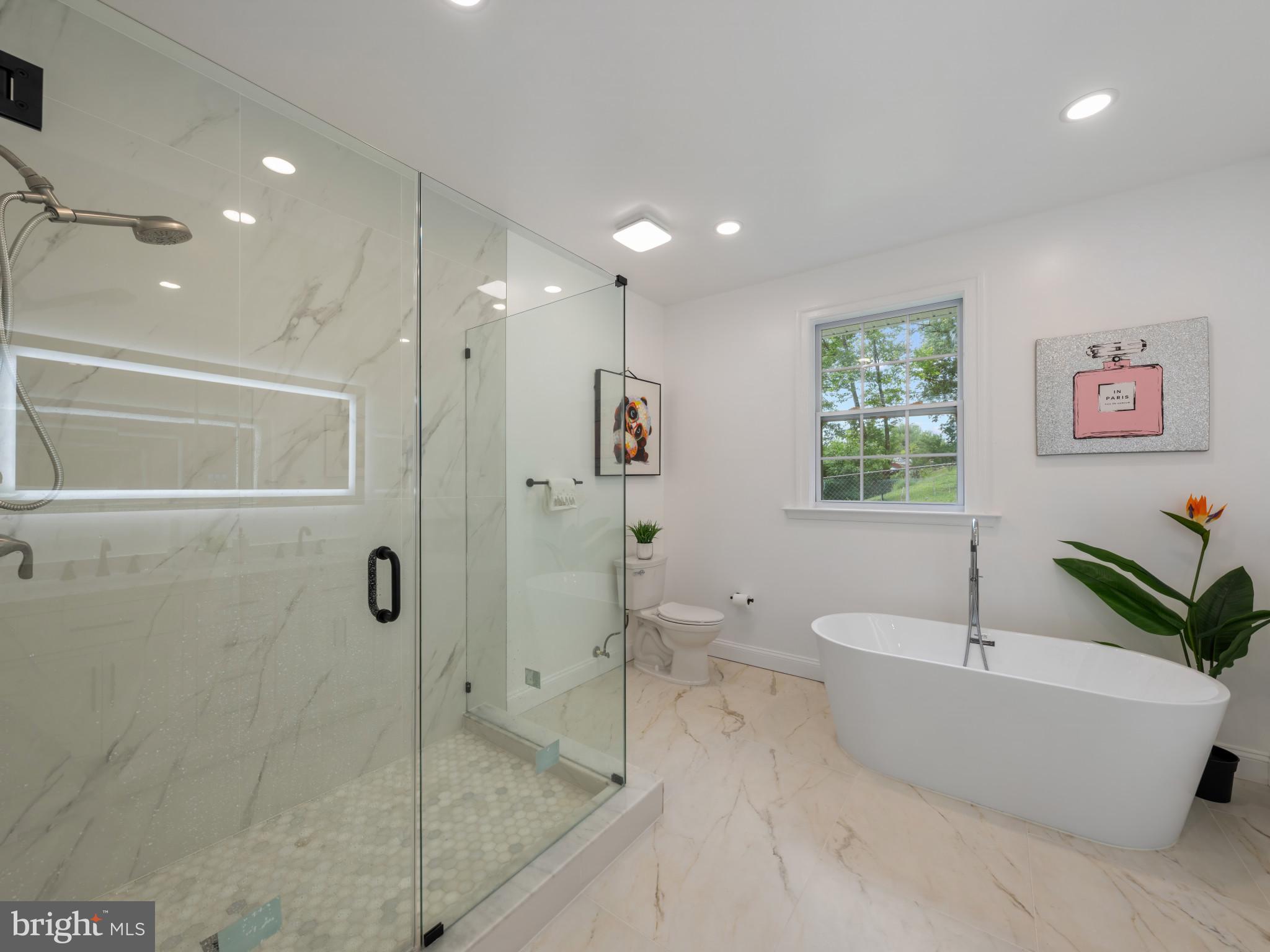 5503 Blacksburg Road Springfield, VA 22151 - Photo 23 of 30 a bathroom with a tub a toilet and a shower