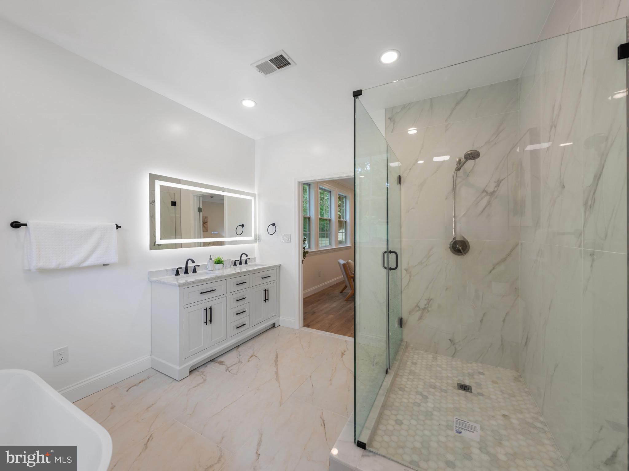 5503 Blacksburg Road Springfield, VA 22151 - Photo 24 of 30 a bathroom with a shower sink and mirror