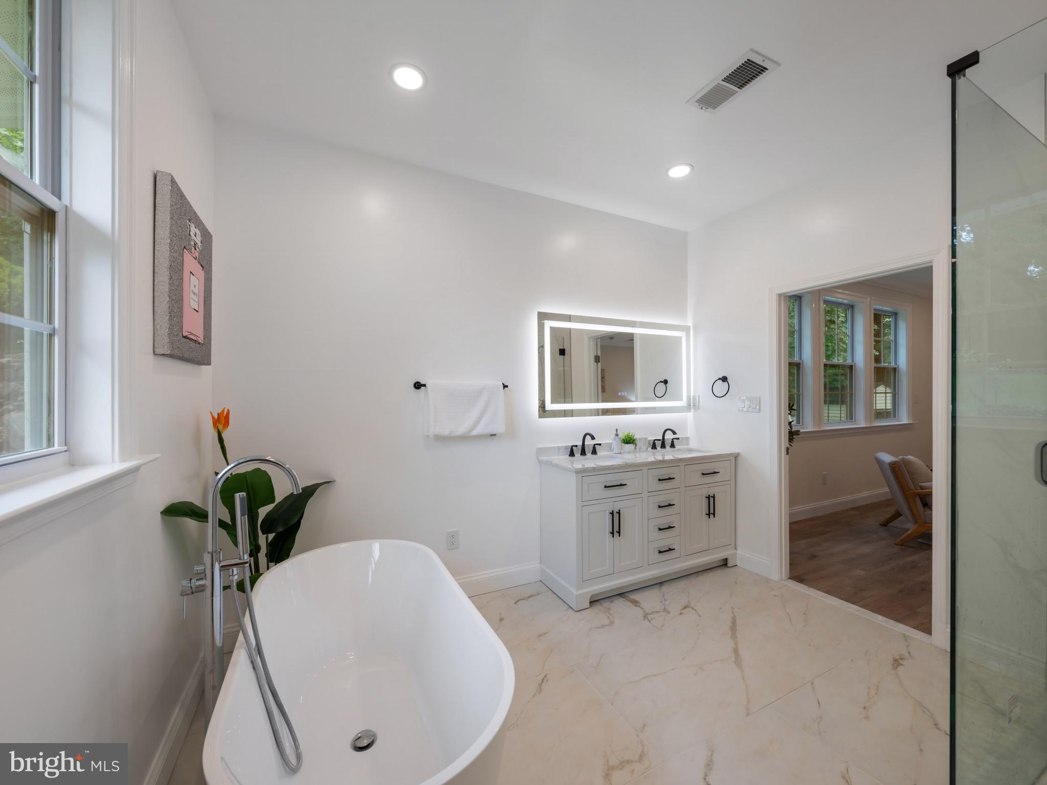 5503 Blacksburg Road Springfield, VA 22151 - Photo 25 of 30 a spacious bathroom with a double vanity sink and a mirror