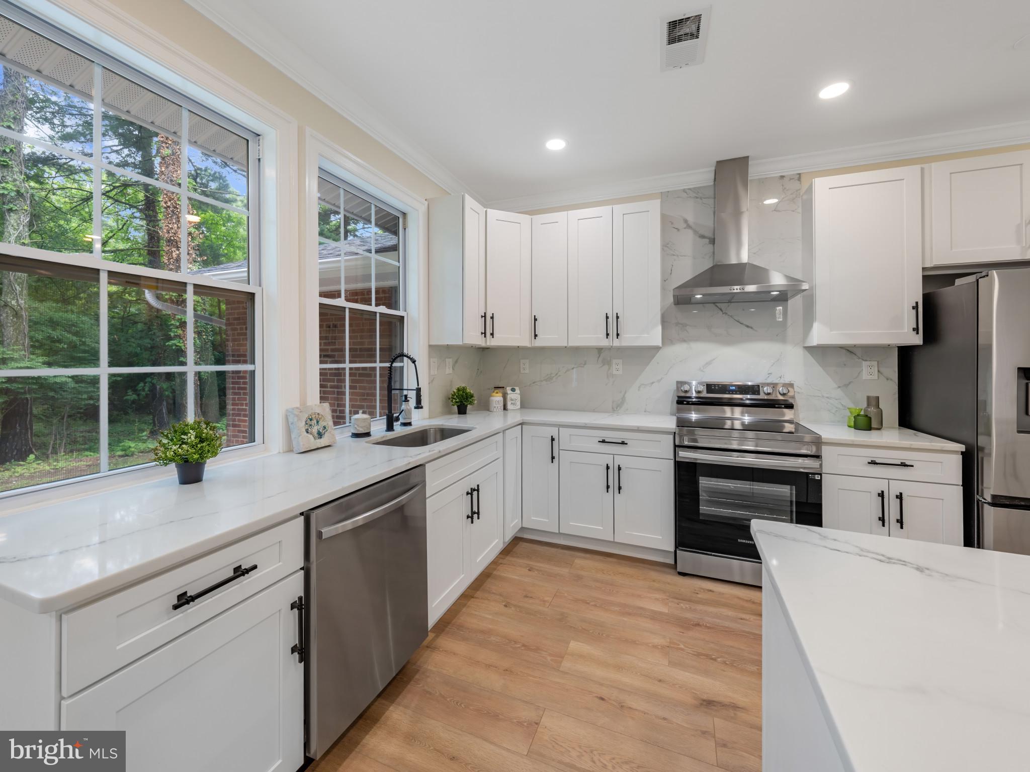 5503 Blacksburg Road Springfield, VA 22151 - Photo 6 of 30 a kitchen with granite countertop a sink stainless steel appliances and cabinets