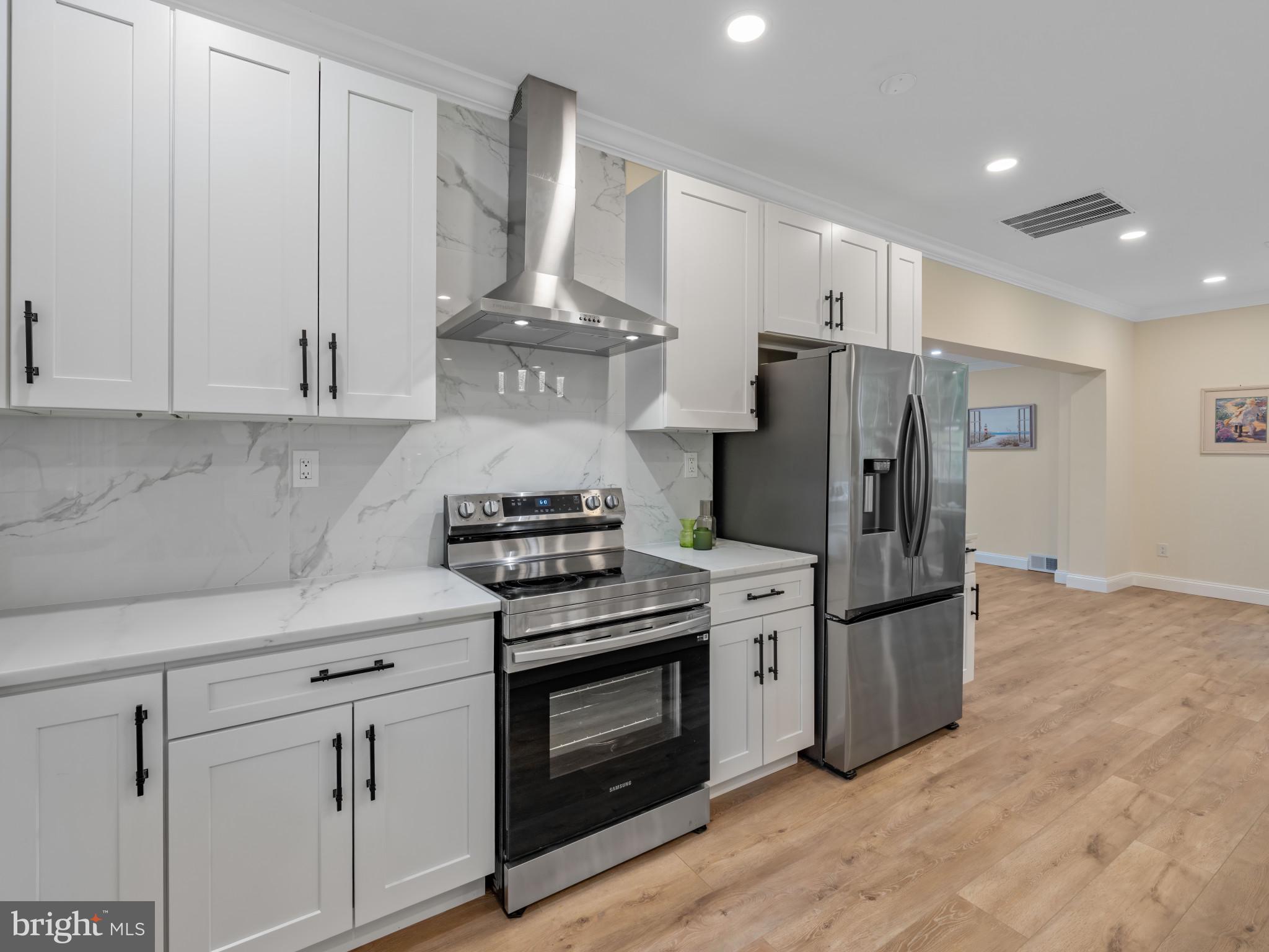 5503 Blacksburg Road Springfield, VA 22151 - Photo 7 of 30 a kitchen with stainless steel appliances a stove a refrigerator and cabinets
