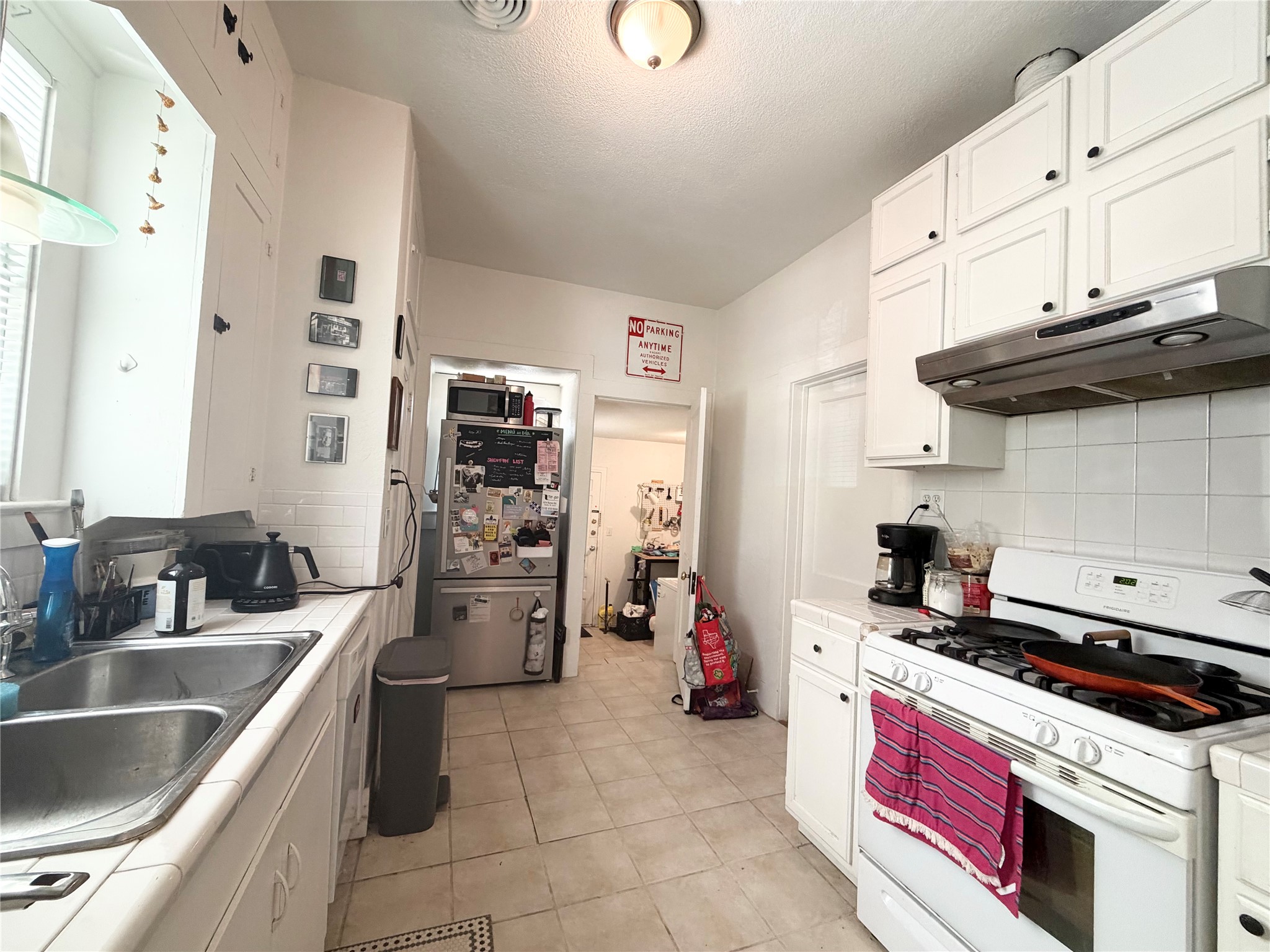 404 West 43rd Street, Unit A Austin, TX 78751 - Photo 7 of 10 a kitchen with a sink cabinets and stainless steel appliances