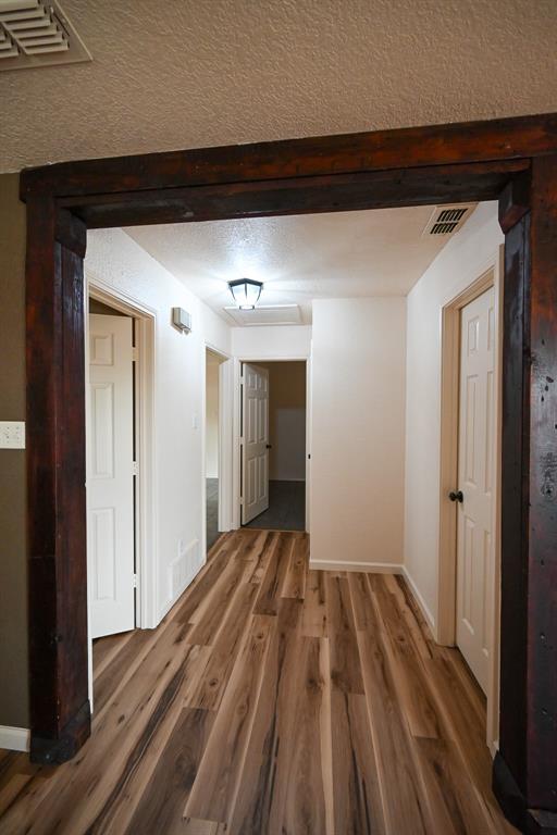 3201 South Garland Street Decatur, TX 76234 - Photo 3 of 20 a view of a room with wooden floor and stairs