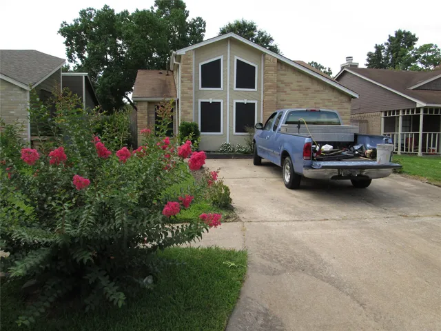 a front view of a house with a garden and pathway