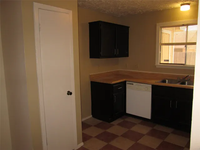 a kitchen with a sink and a microwave