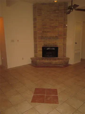a view of empty room with a fireplace
