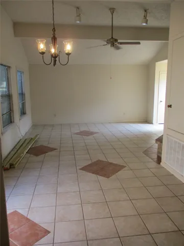 a view of a livingroom with a ceiling fan and glass door