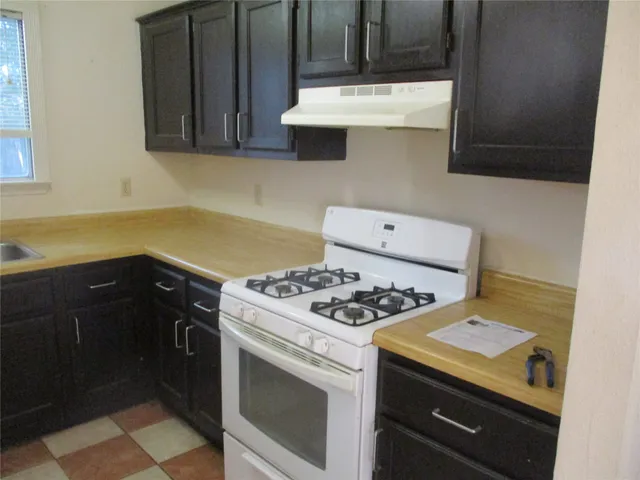 a kitchen with a stove and a microwave