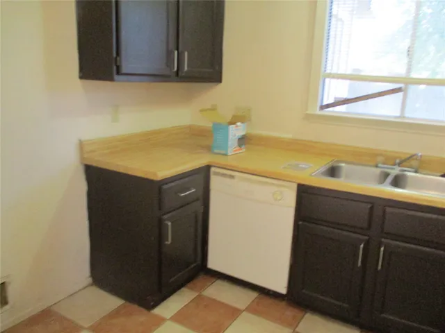 a utility room with a sink washer and dryer