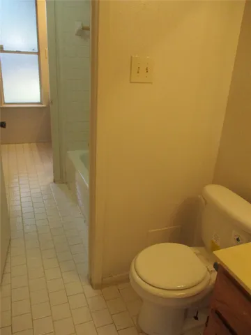 a white toilet sitting next to a shower