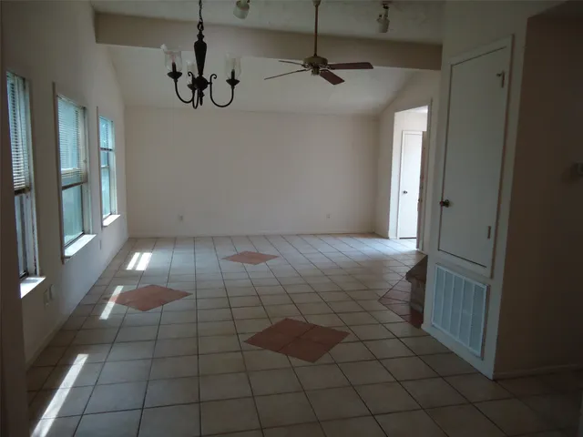 a bathroom with a window and a shower
