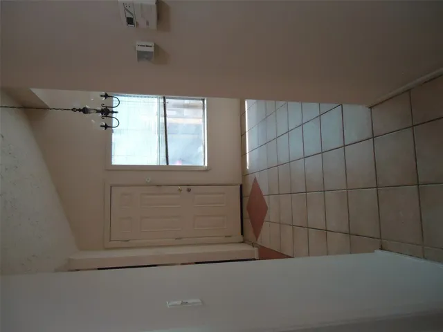 a bathroom with a toilet and a shower curtain