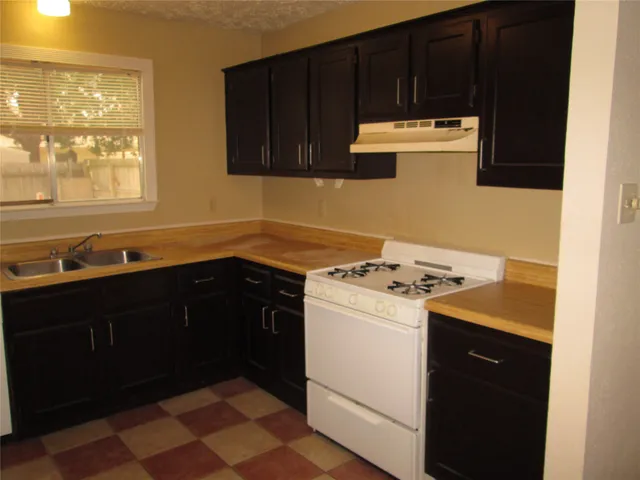a kitchen with a stove and a refrigerator