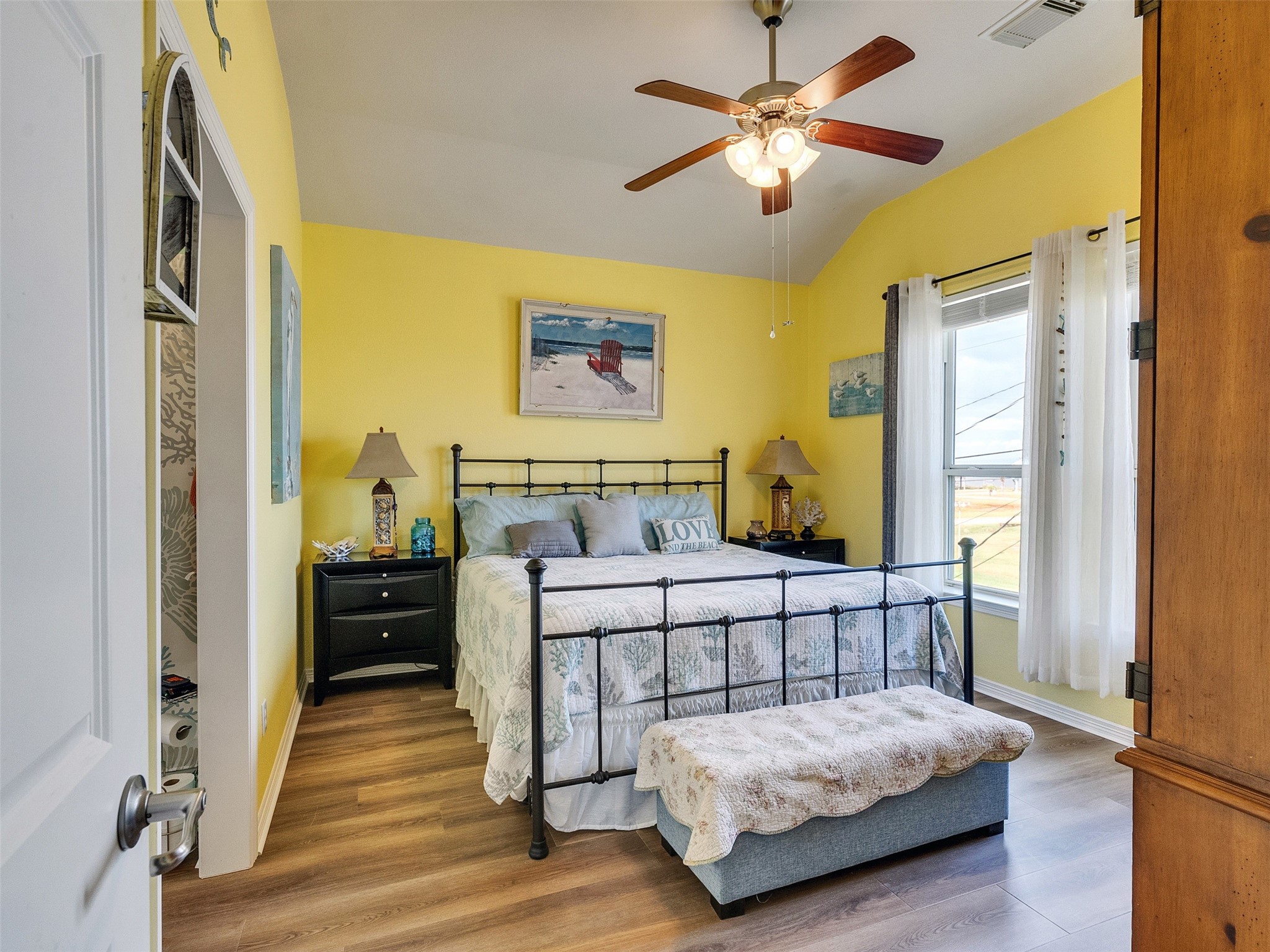 4710 Palm Street Freeport, TX 77541 - Photo 19 of 23 a bedroom with a bed and wooden floor