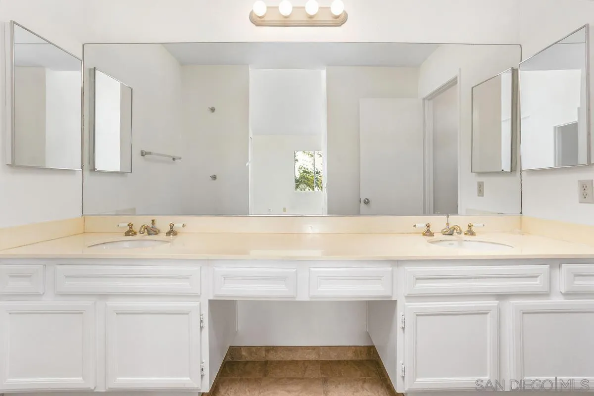 4617 Sheridan Road Oceanside, CA 92056 - Photo 26 of 39 a bathroom with a sink and a mirror