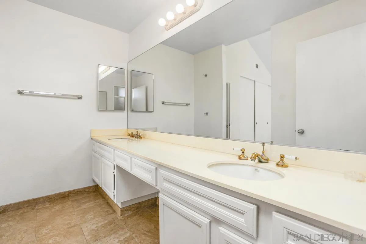 4617 Sheridan Road Oceanside, CA 92056 - Photo 30 of 39 a bathroom with a sink and a mirror