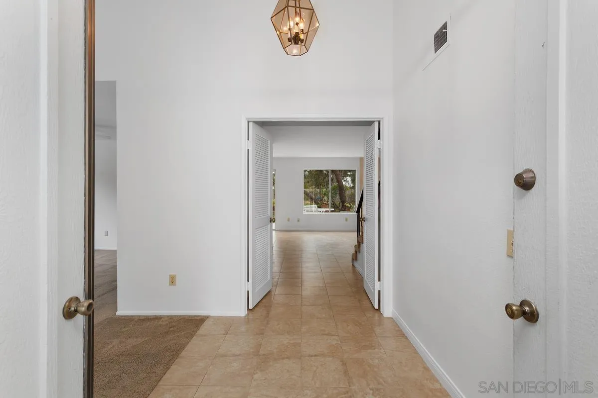 4617 Sheridan Road Oceanside, CA 92056 - Photo 5 of 39 a view of a hallway with wooden floor