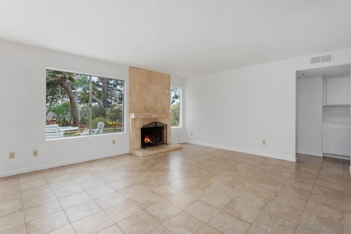 4617 Sheridan Road Oceanside, CA 92056 - Photo 9 of 39 an empty room with fireplace and windows