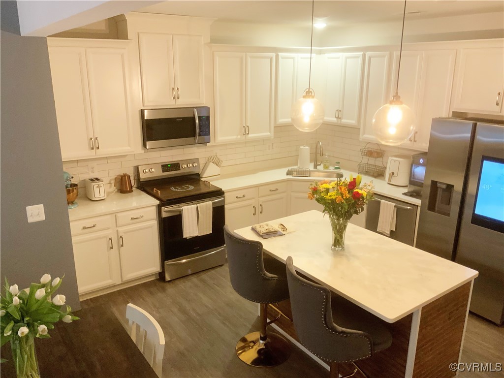 4324 Saunders Station Loop, Unit A Henrico, VA 23233 - Photo 13 of 30 a kitchen with a stove a sink and a refrigerator
