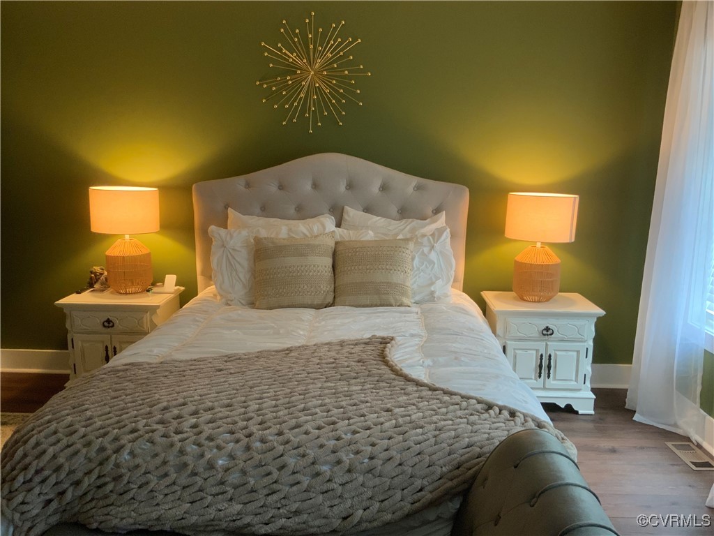 4324 Saunders Station Loop, Unit A Henrico, VA 23233 - Photo 18 of 30 a bedroom with a bed and wooden floor