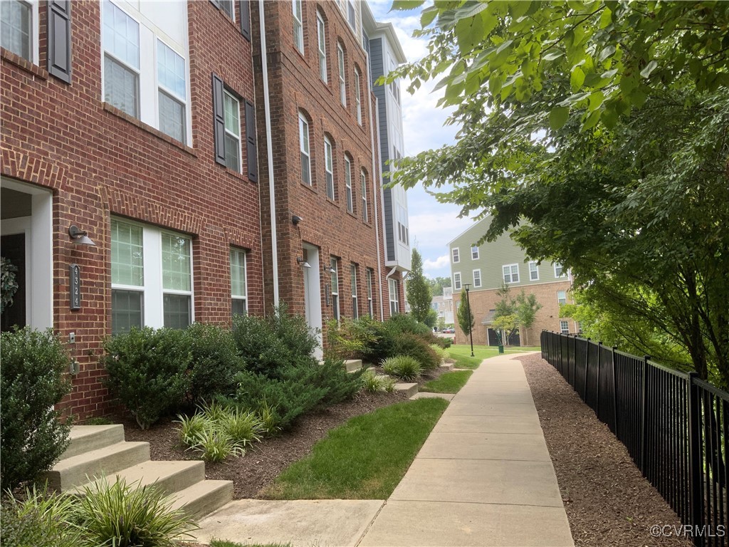 4324 Saunders Station Loop, Unit A Henrico, VA 23233 - Photo 2 of 30 a view of a brick house with a yard