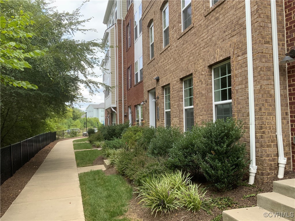 4324 Saunders Station Loop, Unit A Henrico, VA 23233 - Photo 4 of 30 a view of a brick building next to a yard