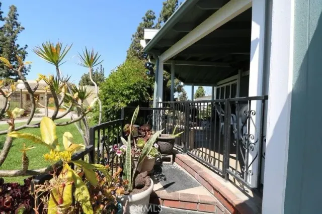a view of a patio with a table chairs and a grill