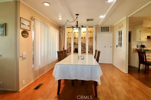 a dining room with furniture window and wooden floor