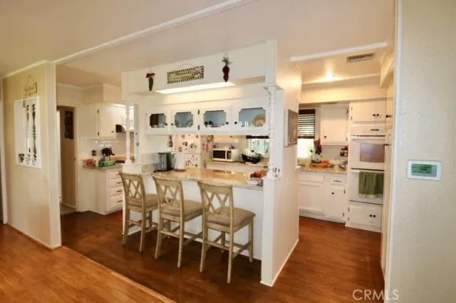 a kitchen with stainless steel appliances a refrigerator and cabinets