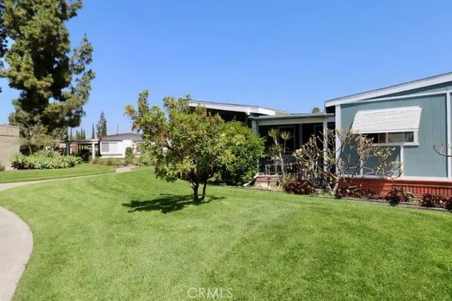 a view of a house with a backyard