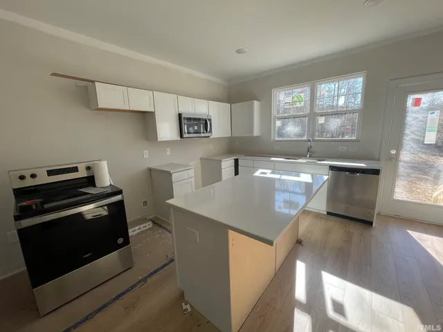 a kitchen with a stove and a white cabinets