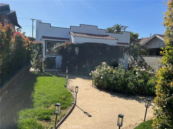 a view of a house with a yard and a garden