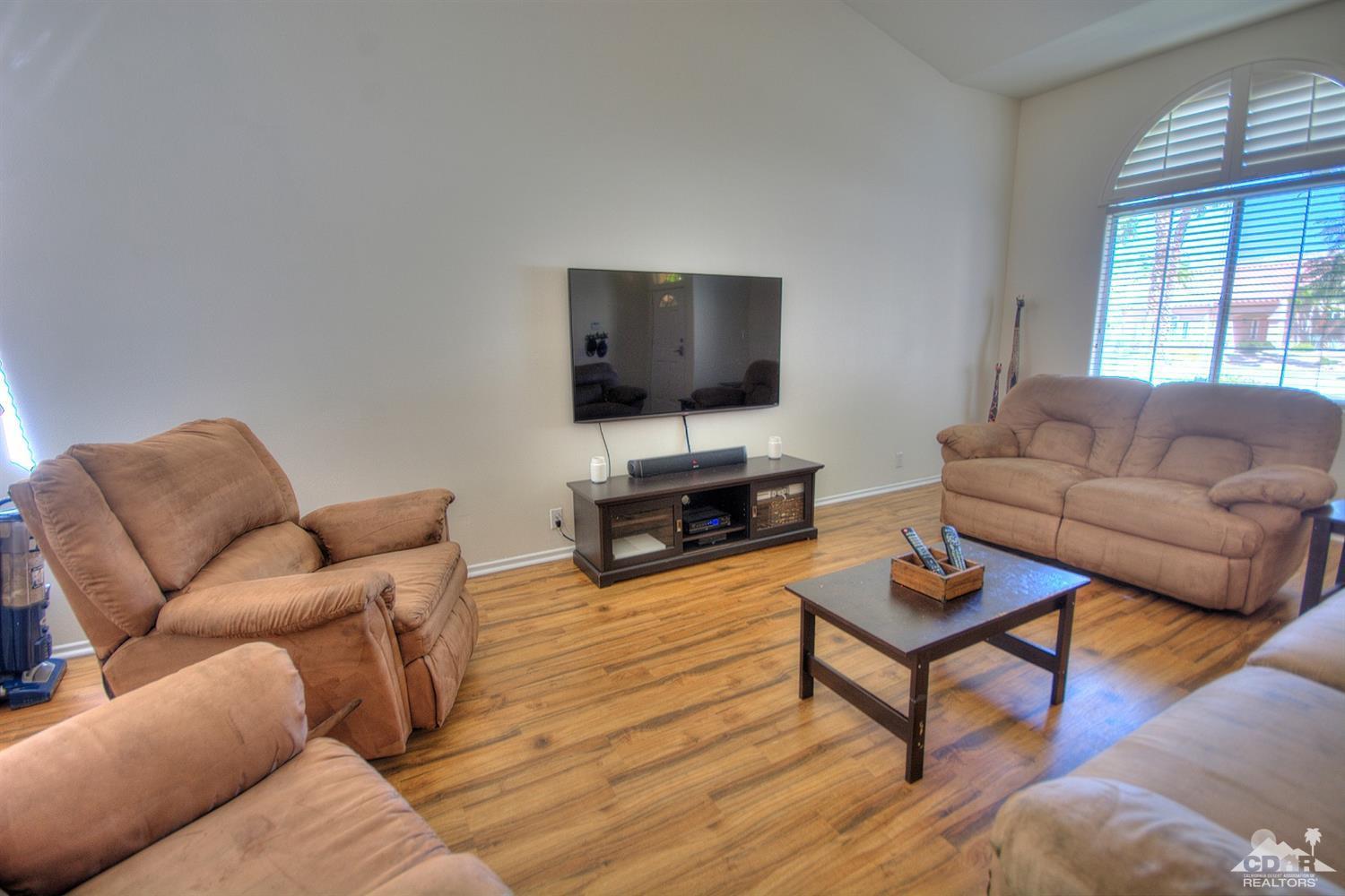 68237 Pasada Road Cathedral City, CA 92234 - Photo 3 of 30 a living room with furniture a flat screen tv and a window