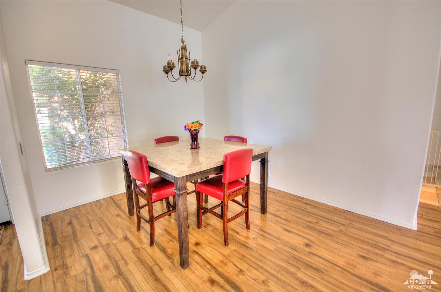 68237 Pasada Road Cathedral City, CA 92234 - Photo 6 of 30 a view of a dining room with furniture window and wooden floor