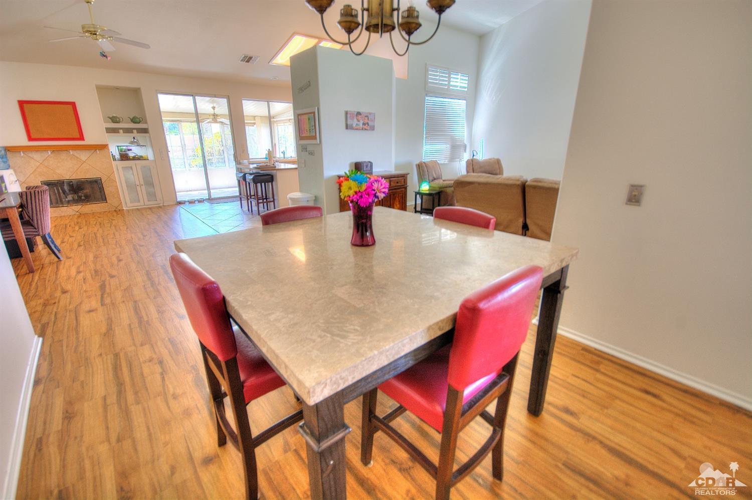 68237 Pasada Road Cathedral City, CA 92234 - Photo 8 of 30 a view of a dining room with furniture and wooden floor